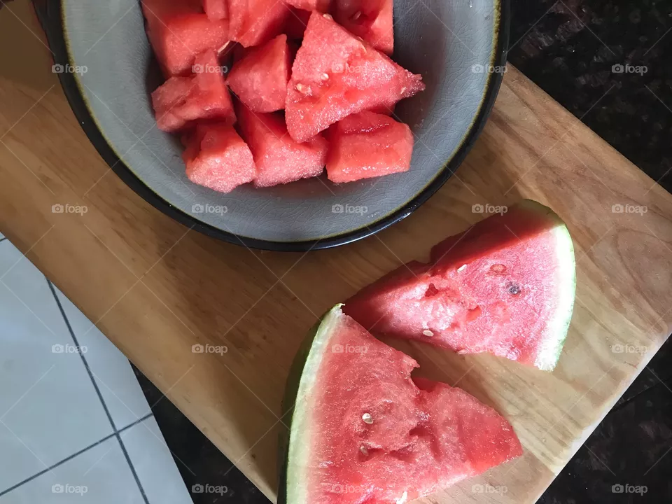 Yummy delicious bright red watermelon sitting in a bowl on the kitchen counter ready to be eaten