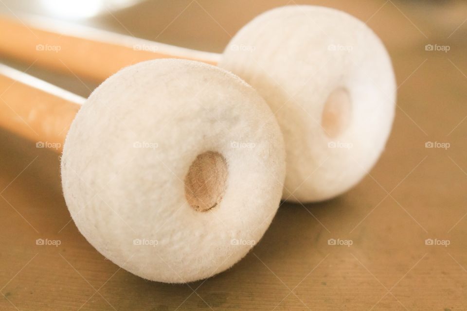 Cymbal beaters on top of a crash cymbal