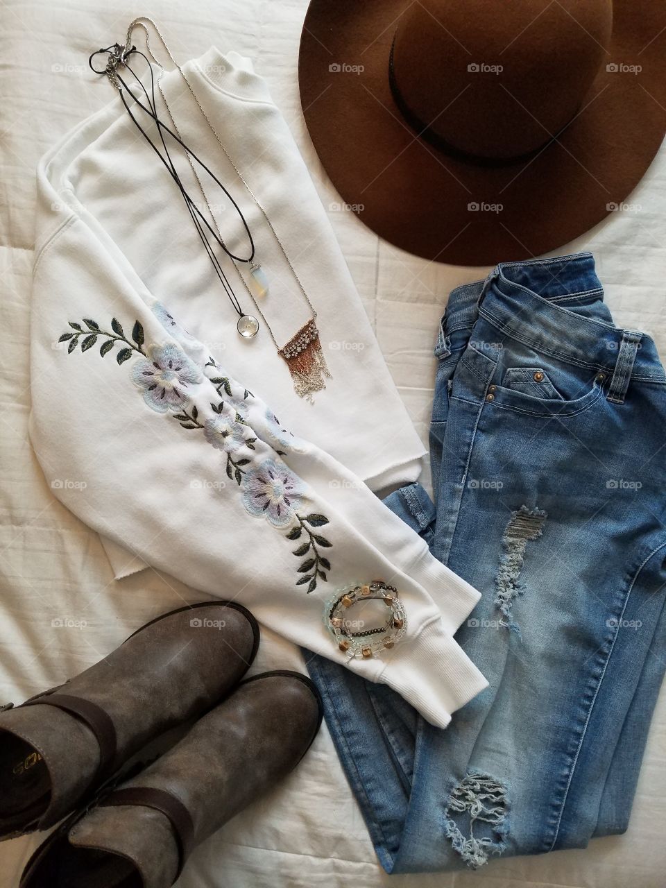 flat lay clothes jeans shirt hat bootsq