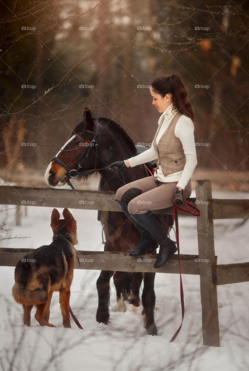 Young beautiful woman with horse and German shepherd dog outdoor portrait at spring day