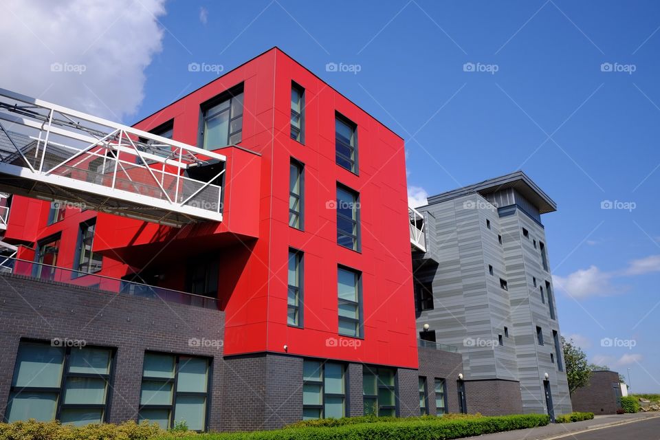 Modern red office building with elevated walkway