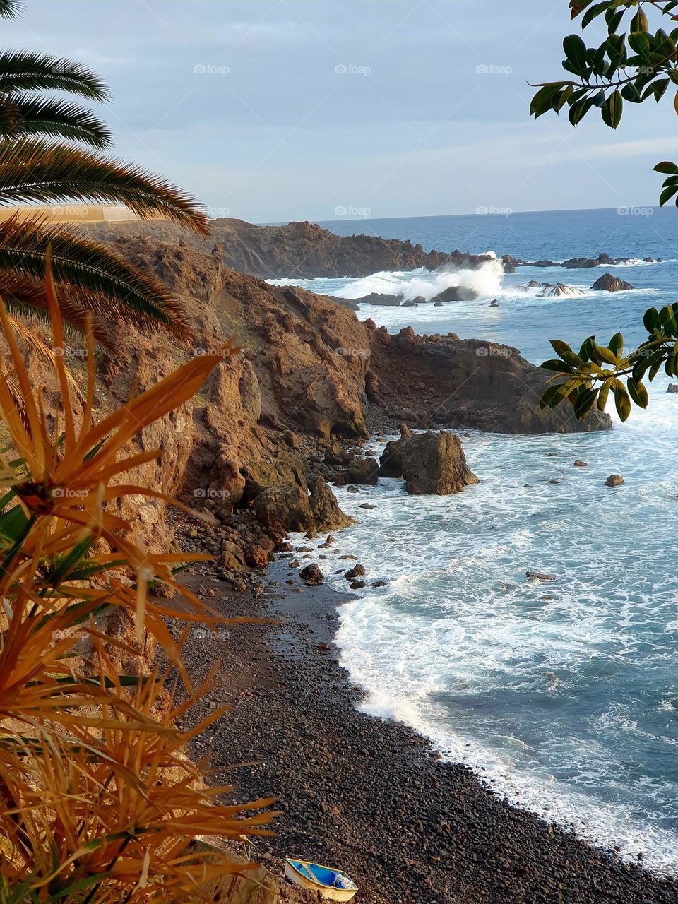 stone coast with surf at the lonely sea