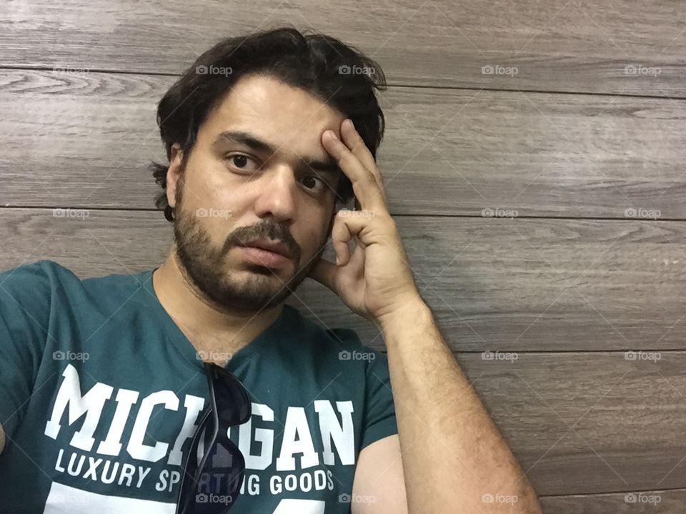 Portrait of a man with hand on head