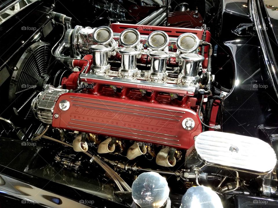 A 8 cylinder engine sits tightly inside a restored and modified 1960 Chevrolet Corvette