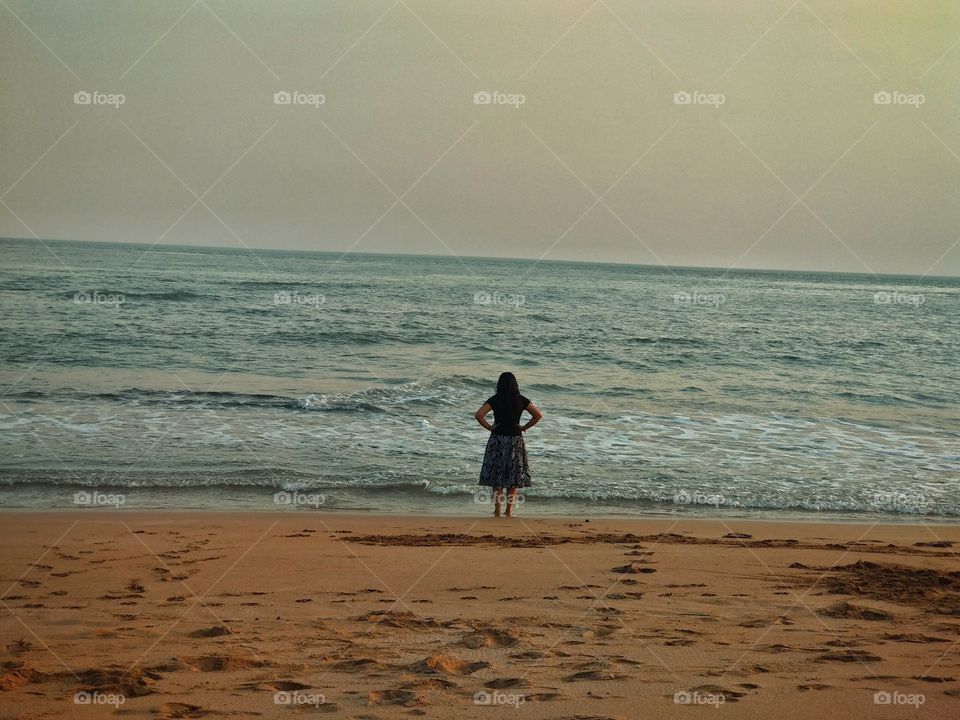 A lady at beach having peace.