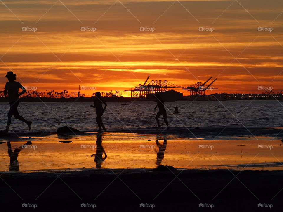 Reflecting runners at sunset 