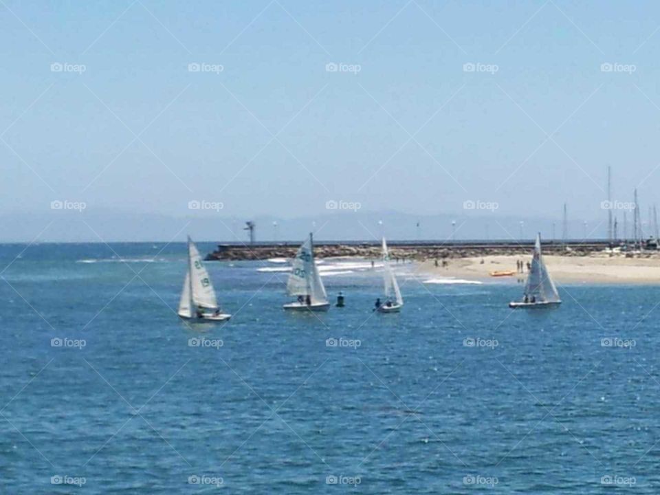 3 sailboats on the seashore