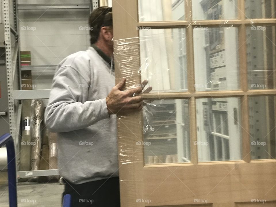 Man looking at door for home improvements 