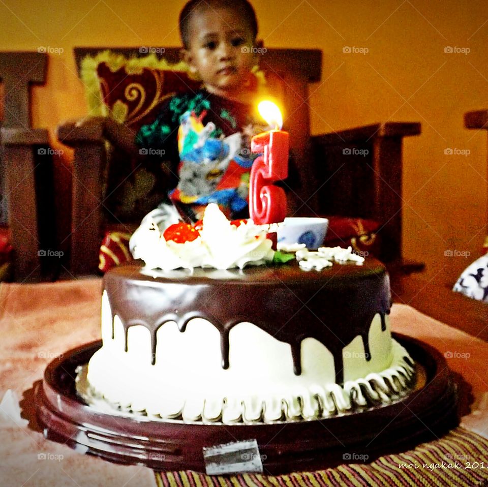 Close-up of birthday cake with illuminated candle