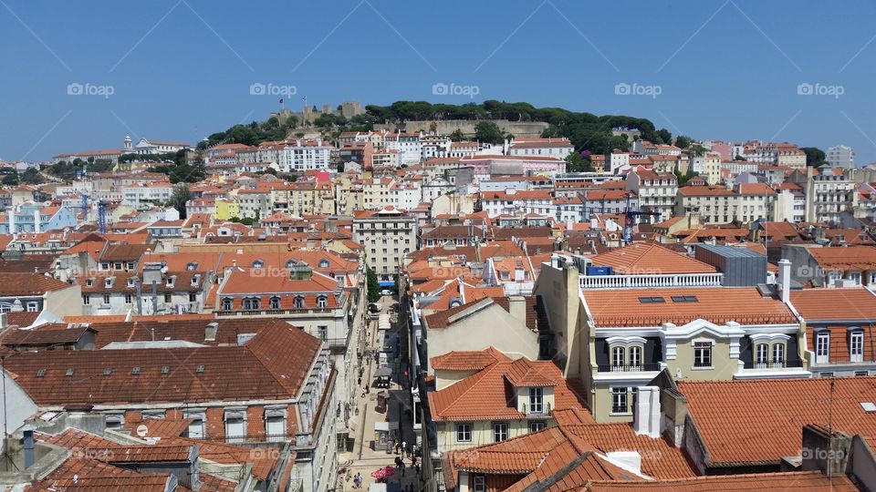 aerial shot of a hilltop covered in quaint European houses in historic Lisbon, Portugal