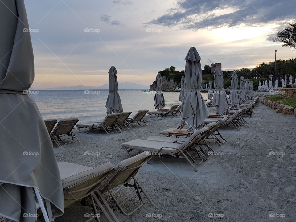 beach sunbeds at sunset