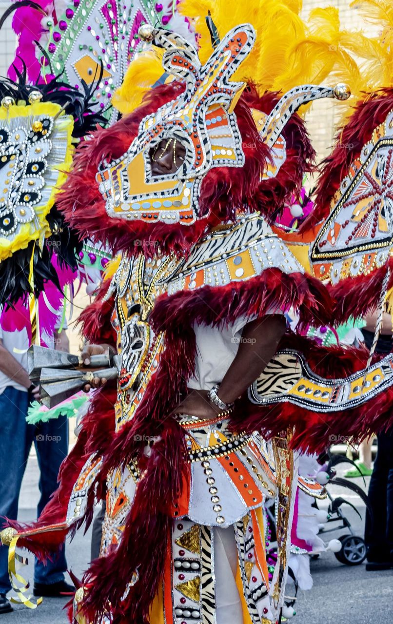 People in a carnival procession wearing elaborate and colourful costumes and headdresses - Junkanoo [Bahamian traditional carnival troupe]