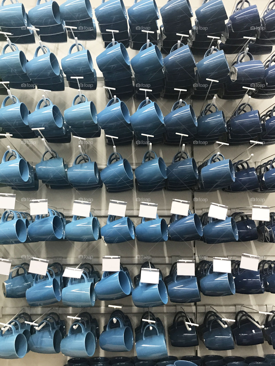 Beautiful blue cups on the shelves on the supermarket