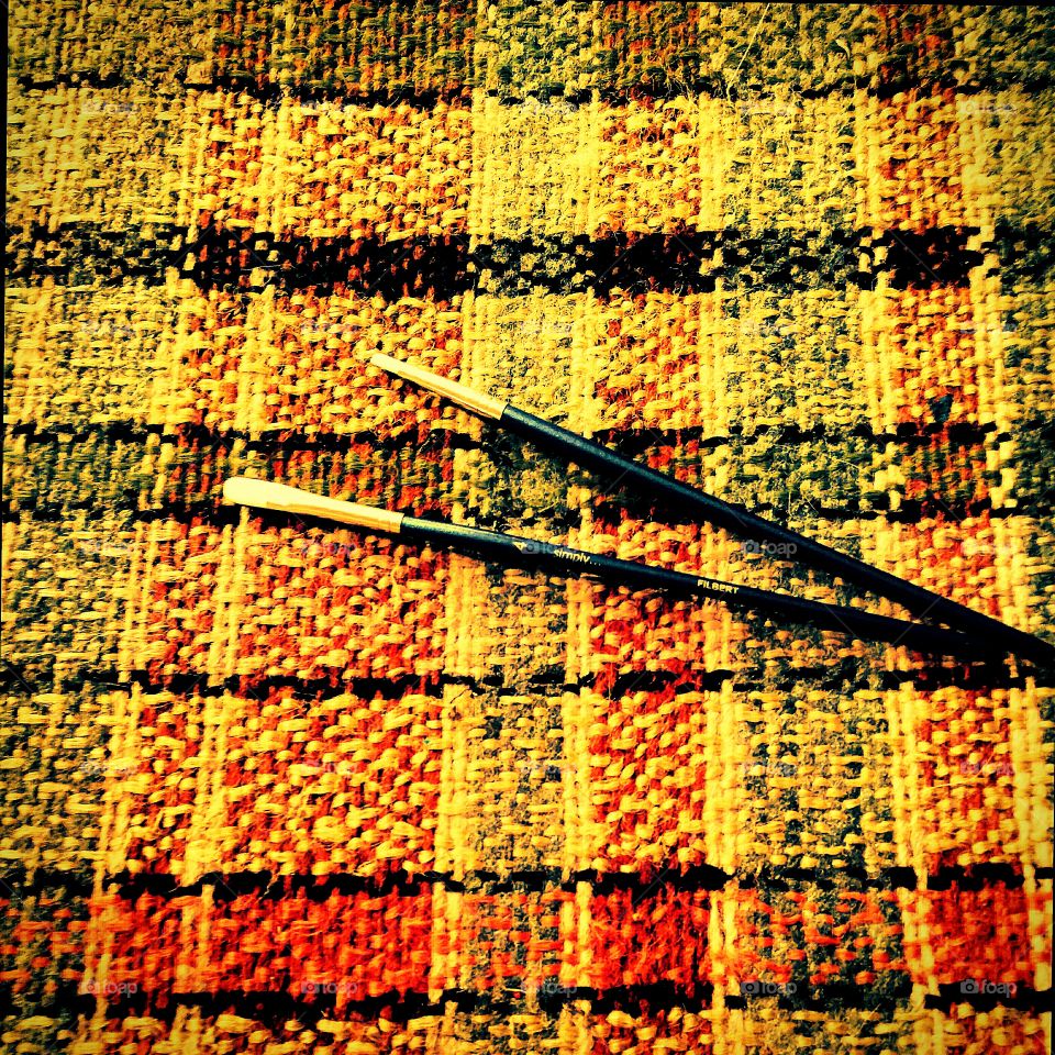 Paintbrushes Against a Plaid Fabric Background