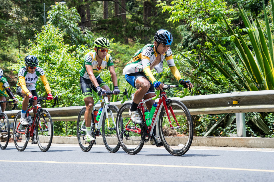 Cyclist racing bicycle on road