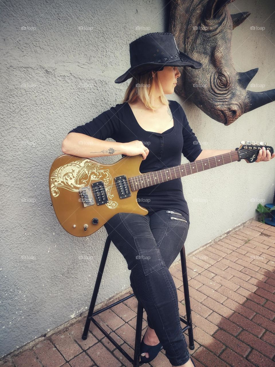 Female sitting with Electric Guitar