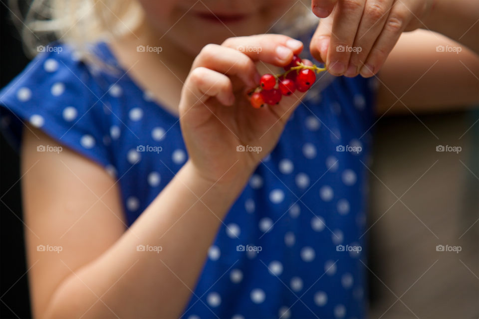 Girl picking red currant