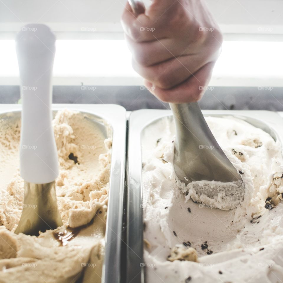 Hand scooping ice cream in a business 