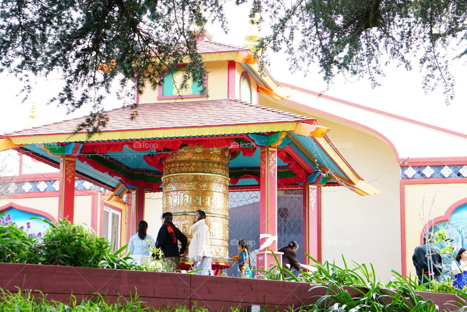 A group of Buddhism ringing the bell for their blessing at a local Temple 
California