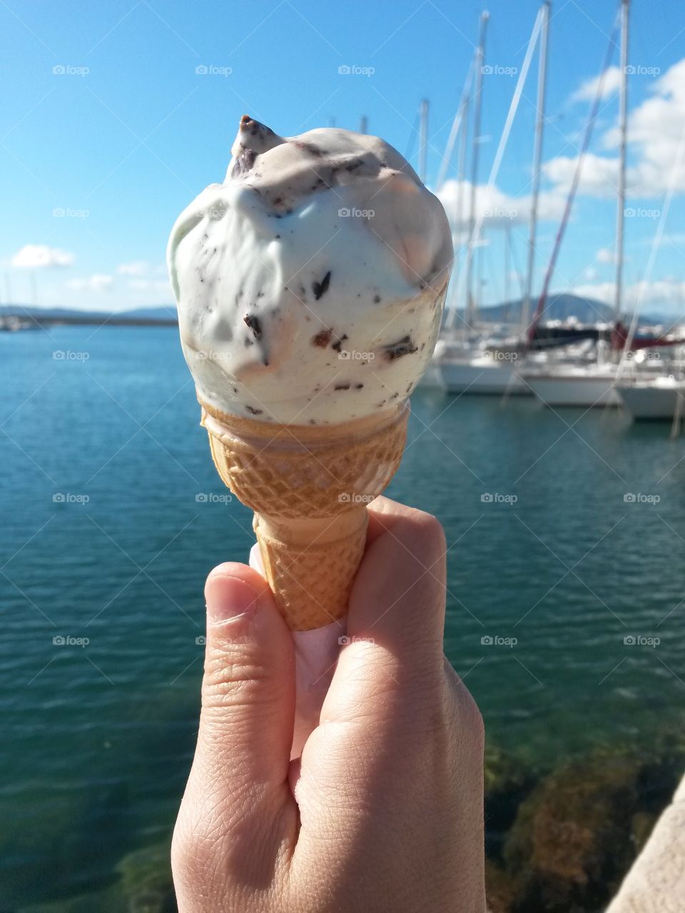 A person holding ice-cream cone