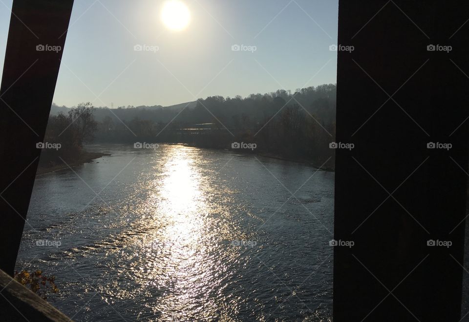 Sunny autumn river, view from a bridge