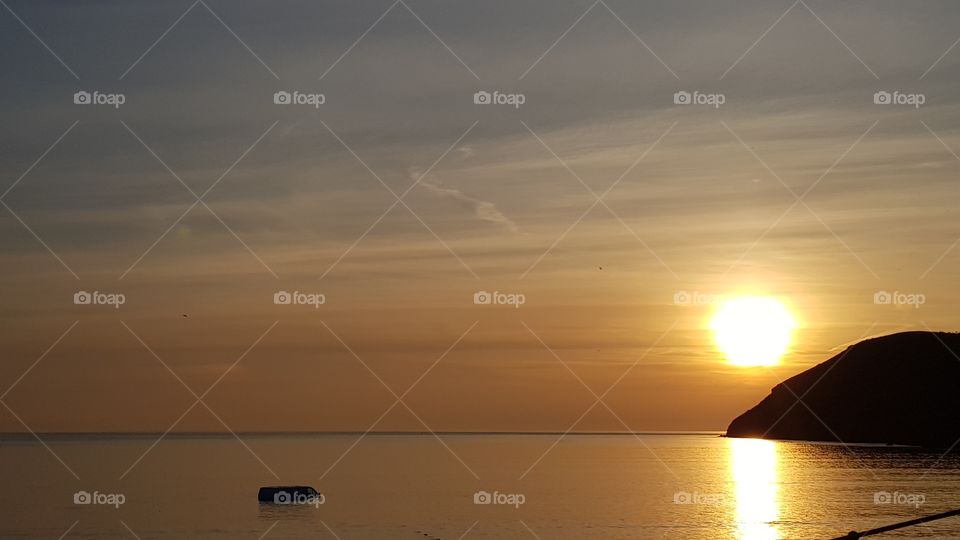 sinking vehicle in calm sunset