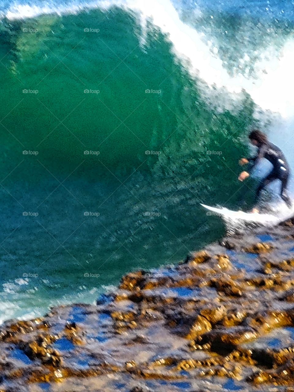 Surfing the exhilarating waves of Santa Cruz on a pristine blue sky day.