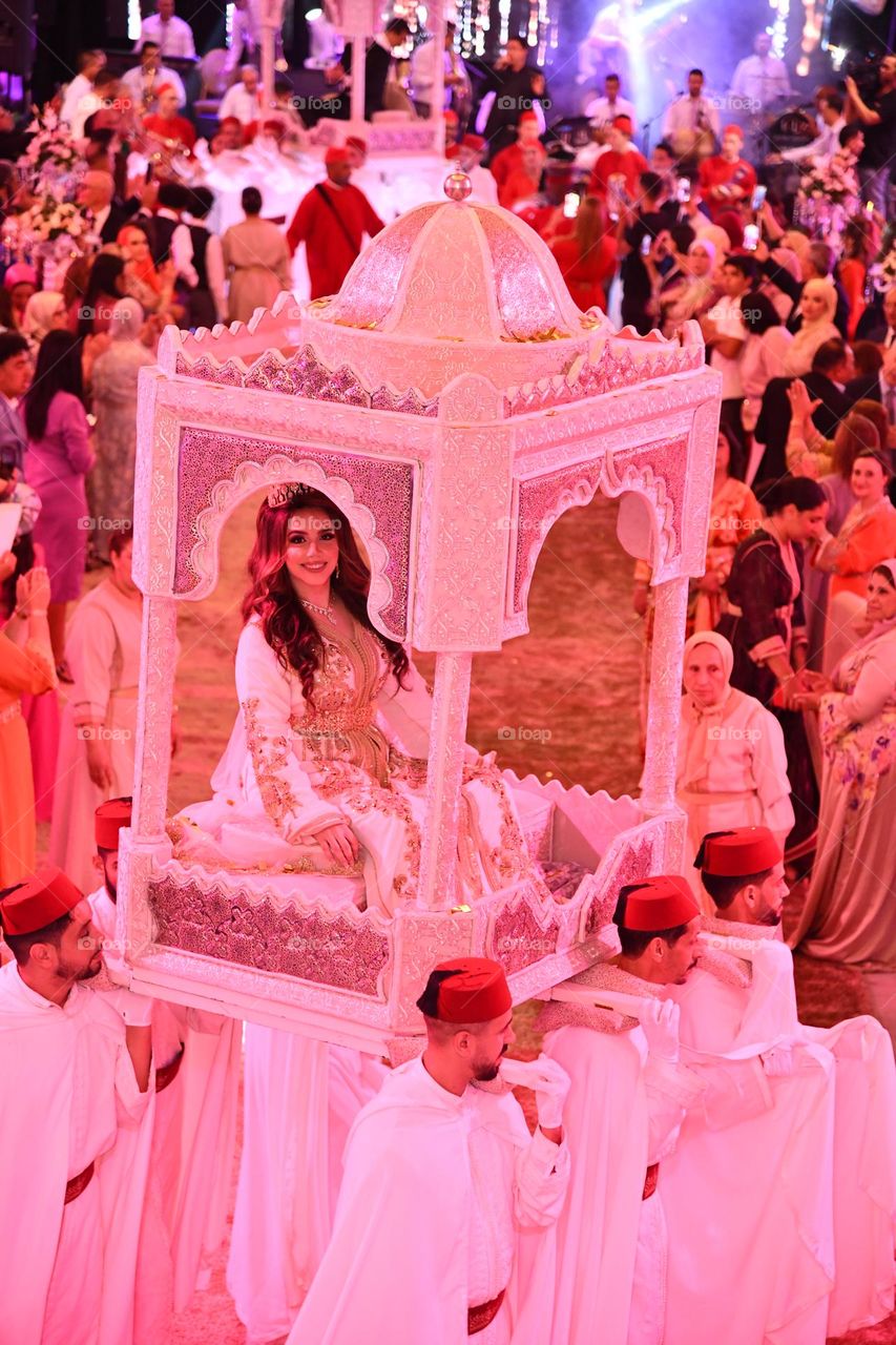 Moroccan Bride entering wedding venue in Fes, Morocco wearing traditional Moroccan dress and carried on “amaria”! 