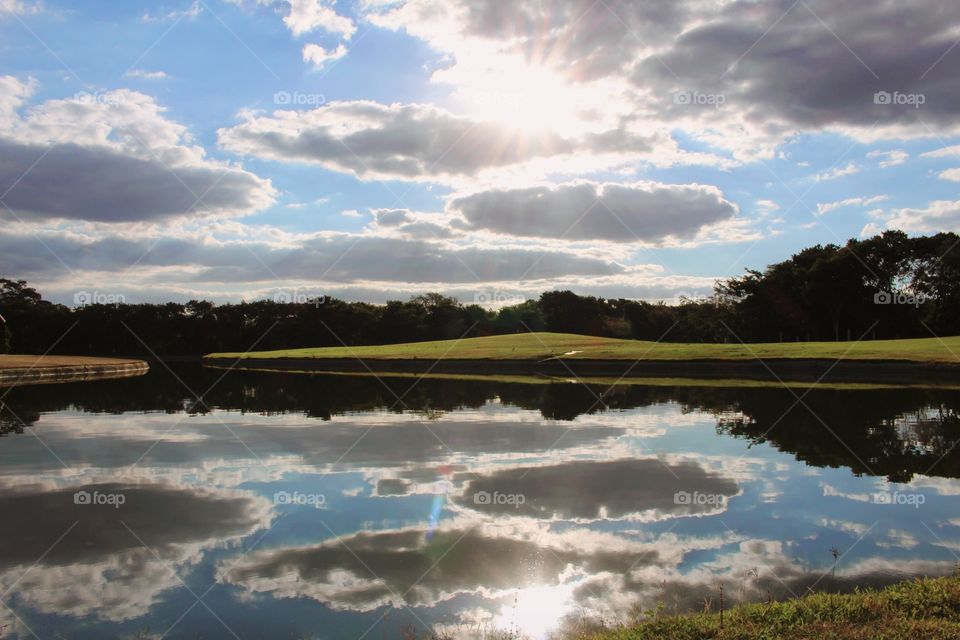 Reflection of the sky on the lake at a summer day end