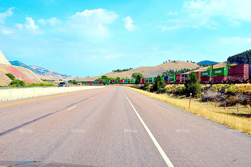 Transportation. Empty road and busy railroad