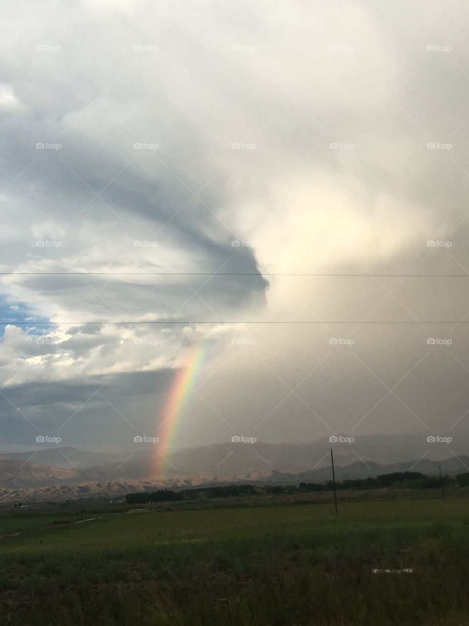 Clouds spilling rainbow