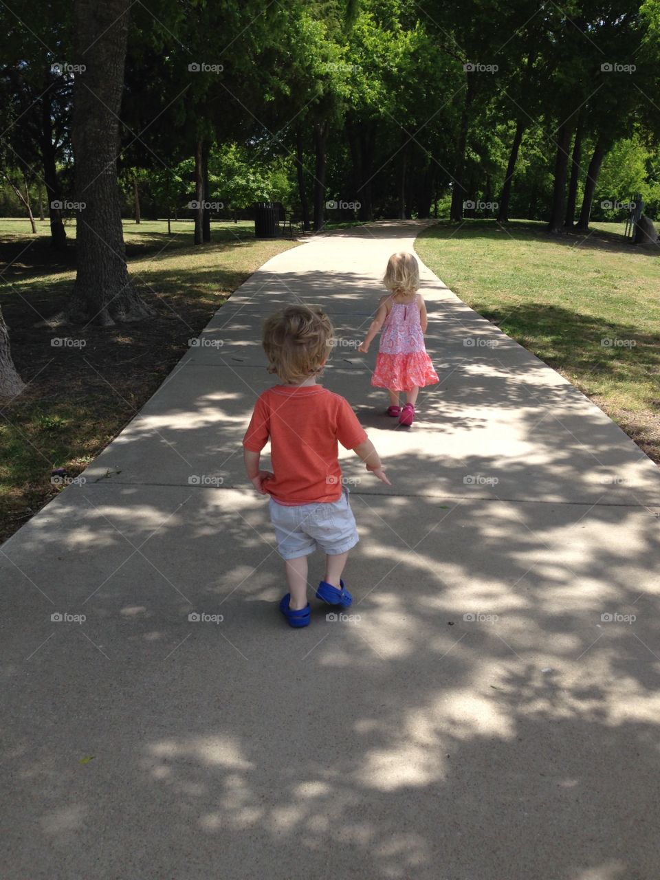 Walk in the park. Twins taking a walk in the park