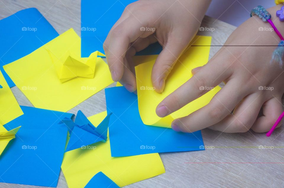 The child holds the origami cheering