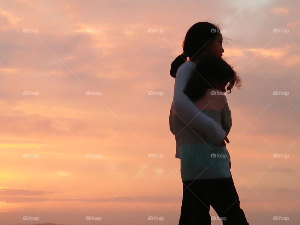 best friends looking at the sunset.