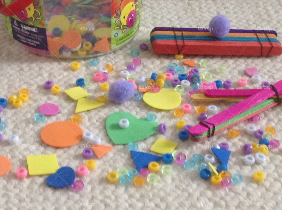 Colorful beads, popcicle sticks and different shape stickers for arts and crafts supplies. 