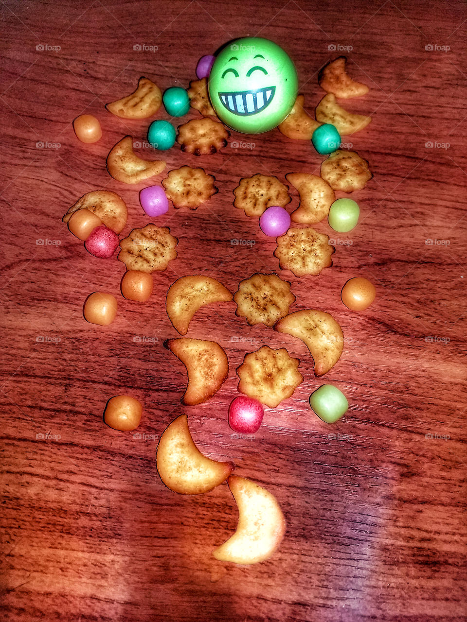 colourful snacks with smile face in wooden table