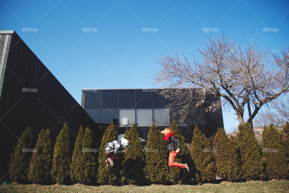 Two friends jumping with joy
