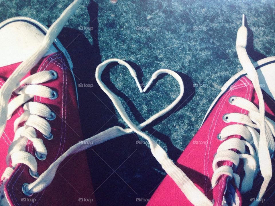 Young love concept heart shape laces pair red 