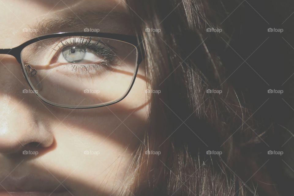 Half face of young girl with eyeglasses