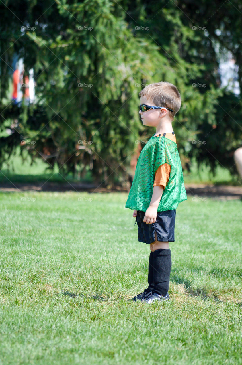 Young boy outdoors in soccer gear