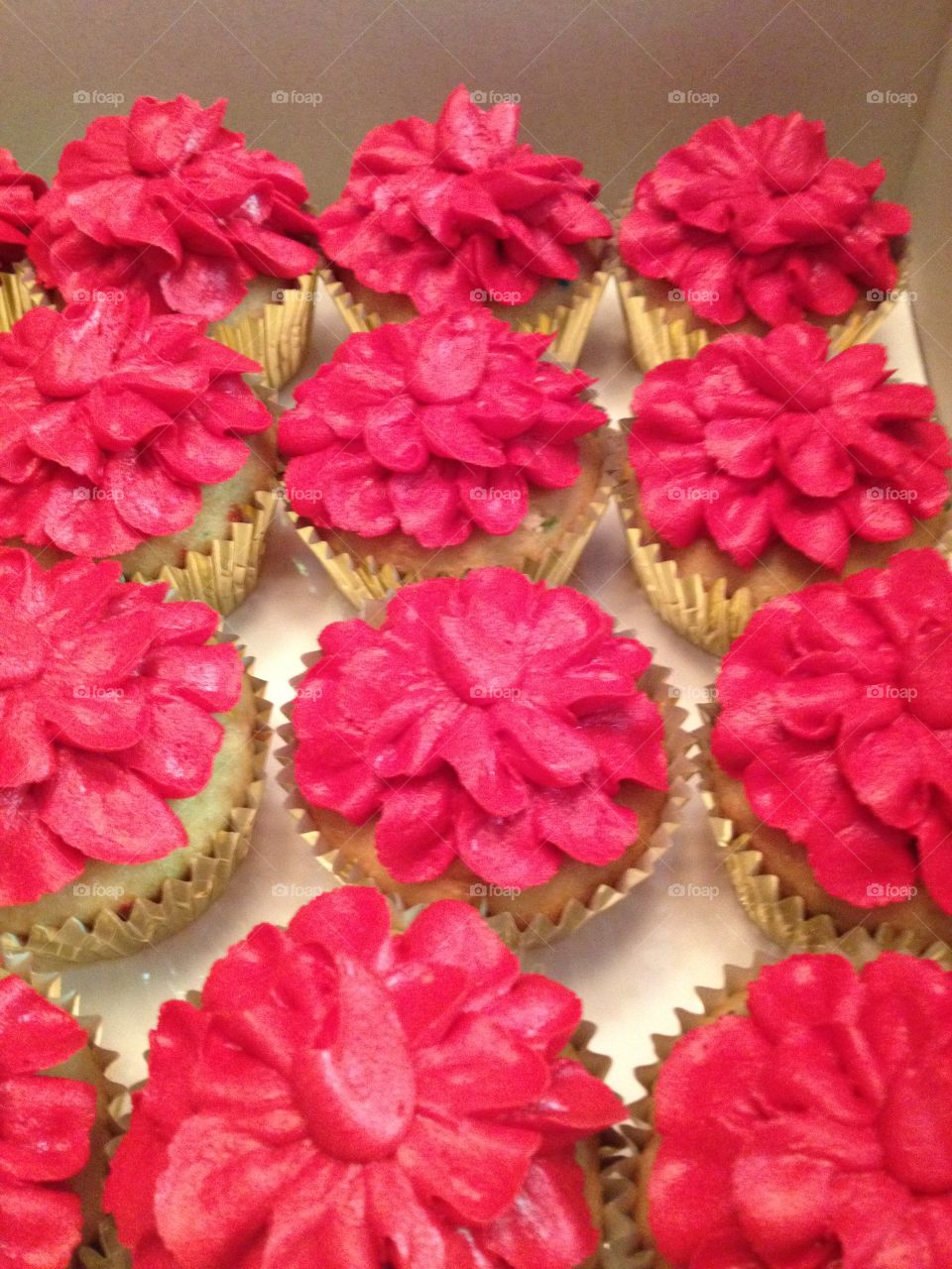 Red petal cupcakes in  gold cups