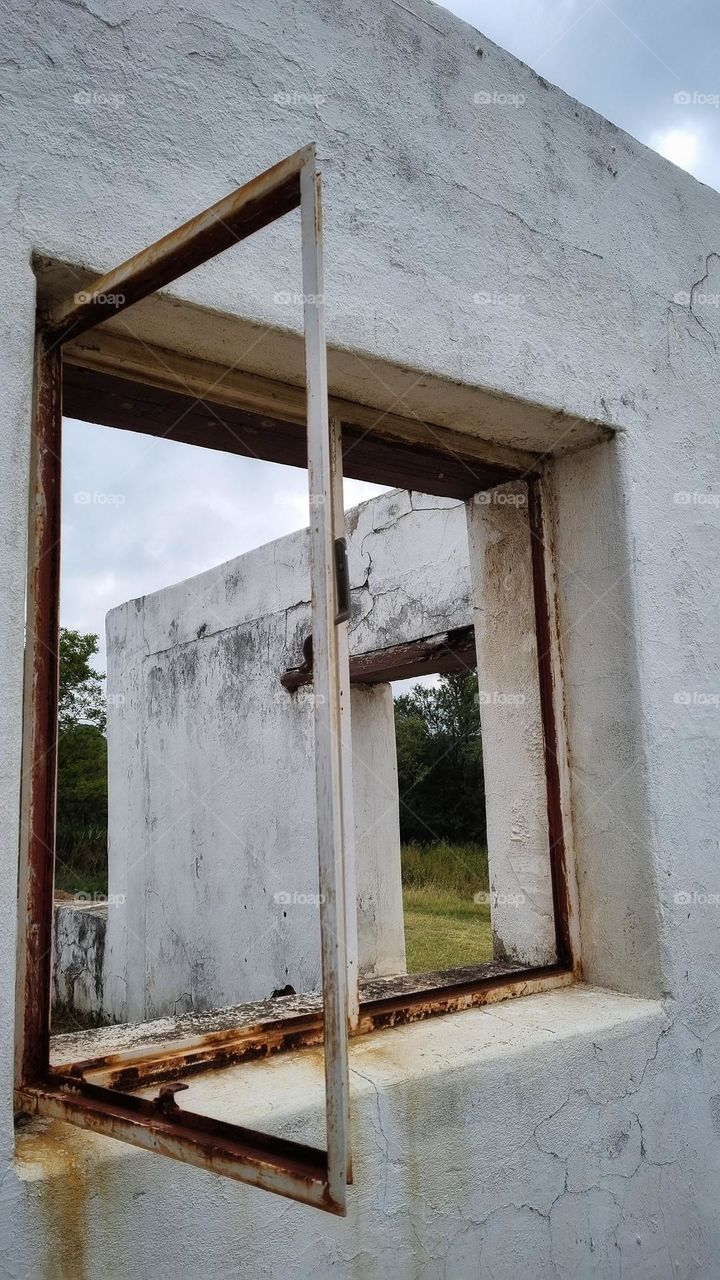 looking through the window of a abandoned homestead