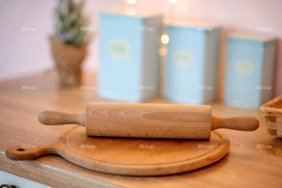 Festive winter cozy kitchen interior with garlands, decorations and gifts.  Christmas dinner at the decorated table.