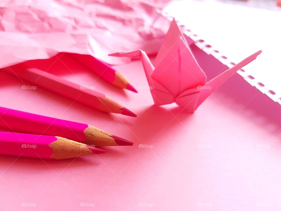 Pink paper crane with colored pencil