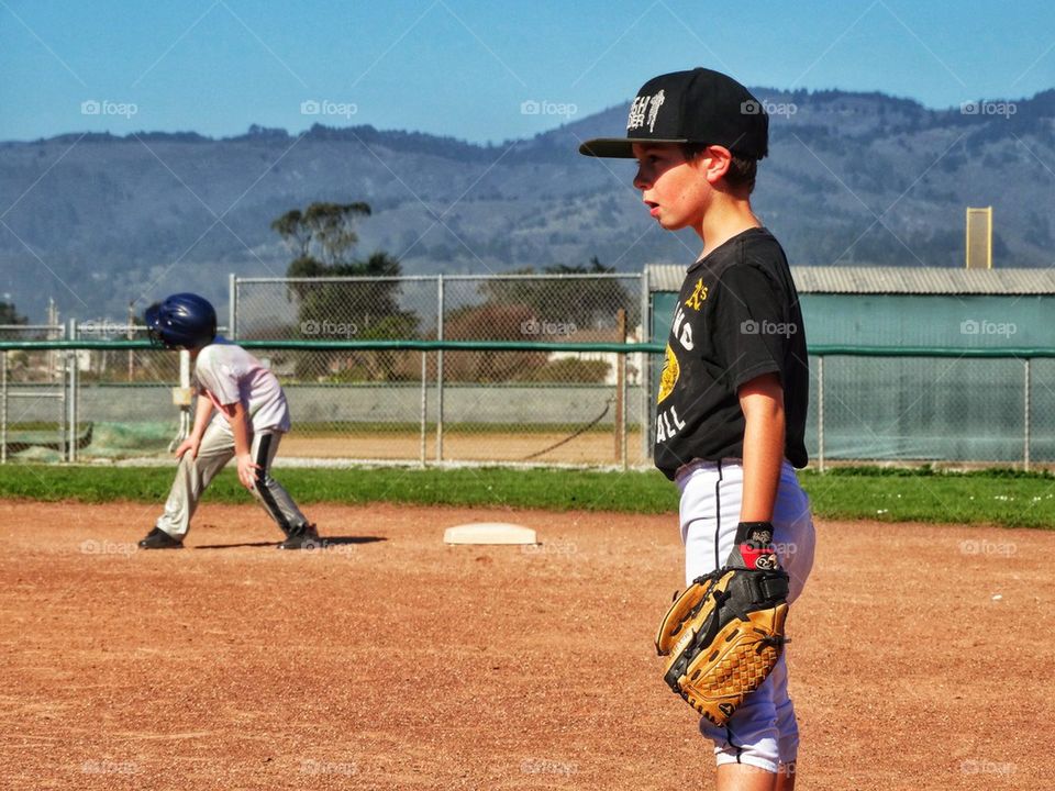 Young Boys Playing Little League Baseball. Boys Playing American Little League Baseball
