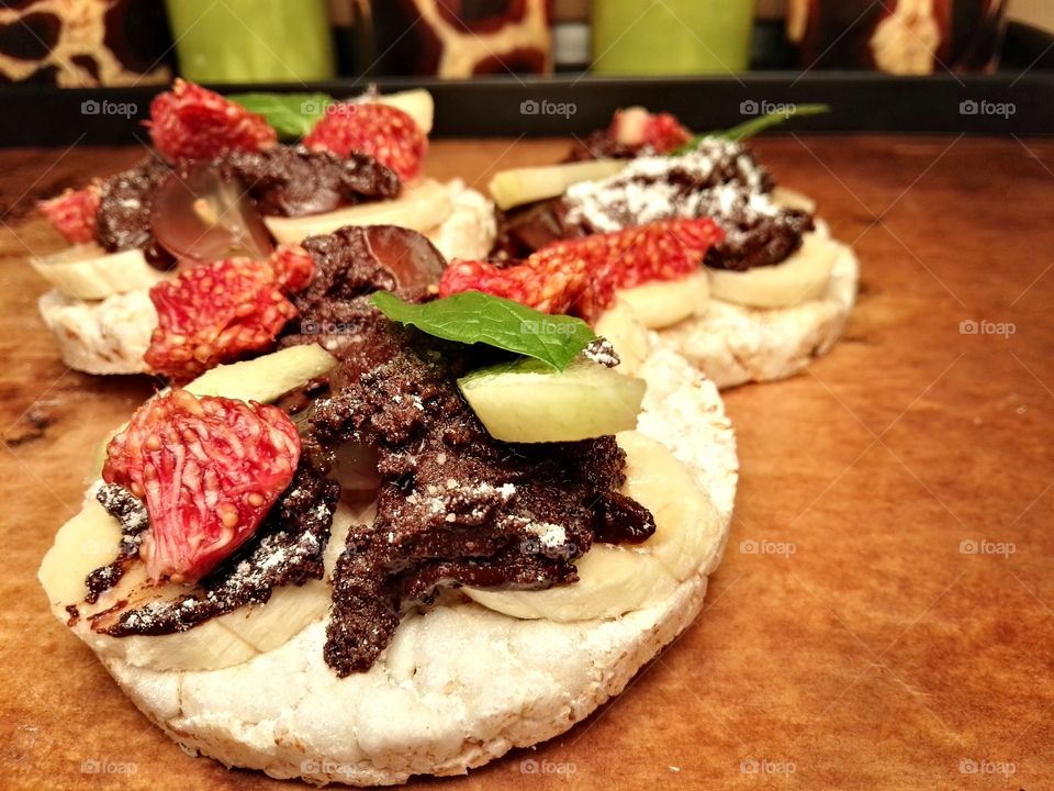 Healthy sweets with fruits and dark chocolate on a rustic background