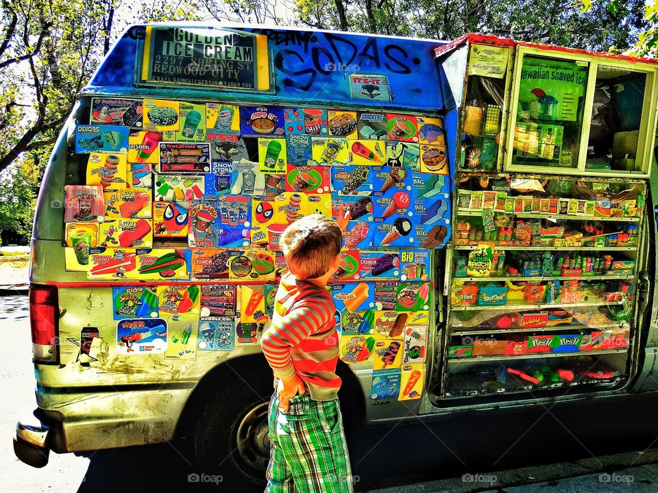 Boy At An Ice Cream Truck. Summertime Scene During Golden Hour
