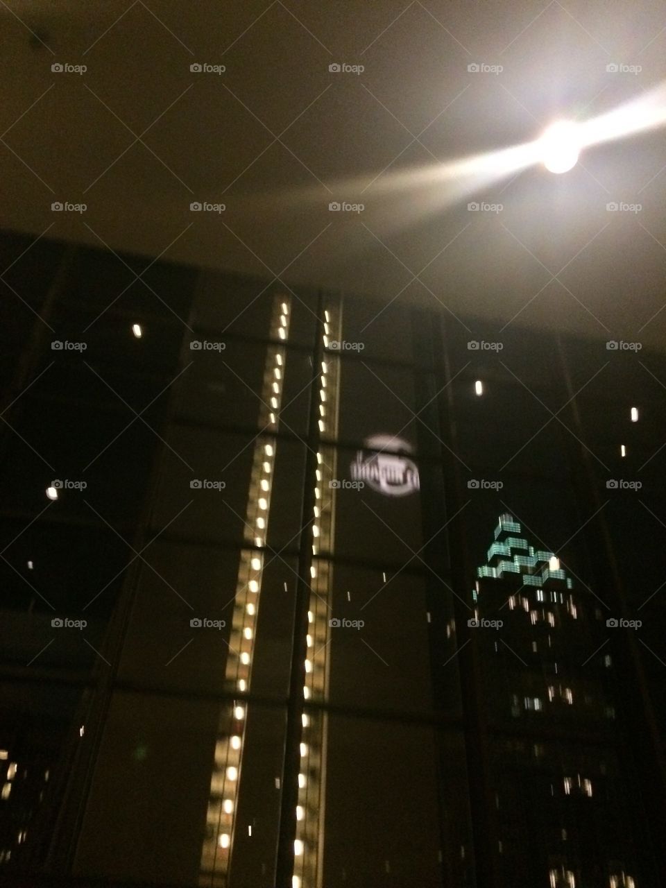 Dragoncon symbol spotlight on downtown hotel in Atlanta Georgia. 