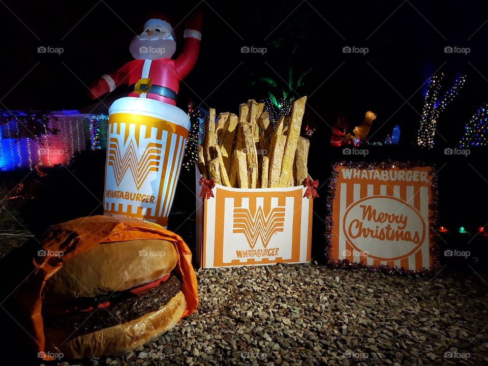 WhataChristmas themed giant Christmas decorations including a burger, fries and a drink. Whataburger is a Texas fast food restaurant chain.