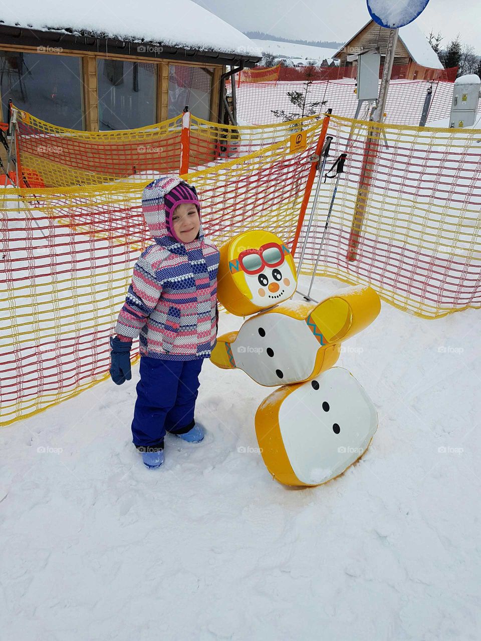 Small girl having fun on snow